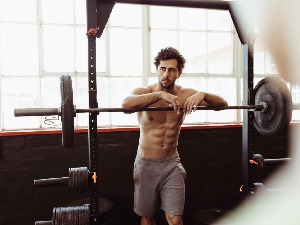 Strong man lifting a barbell in the gym