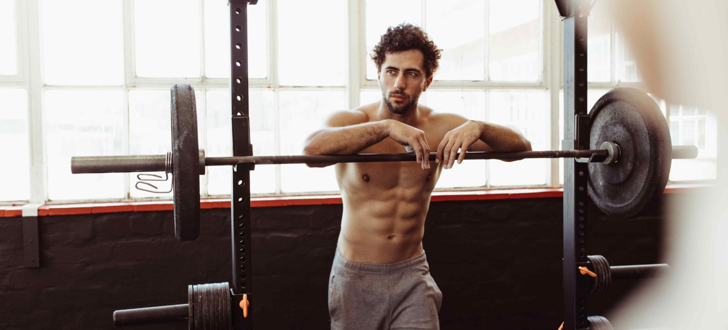 Strong man lifting a barbell in the gym