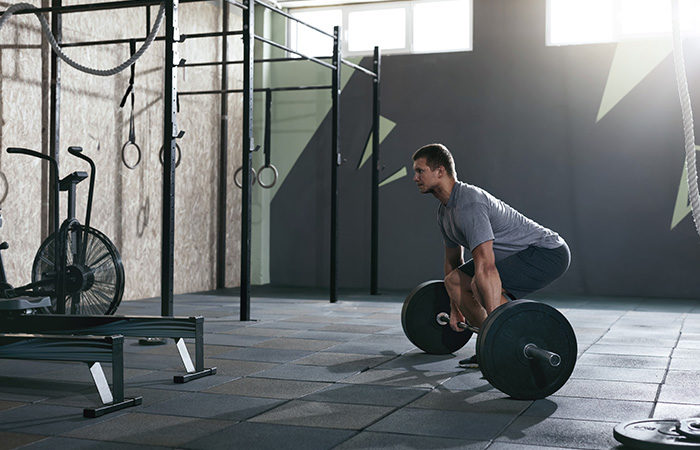 Man gym barbell deadlift strong lean muscular body