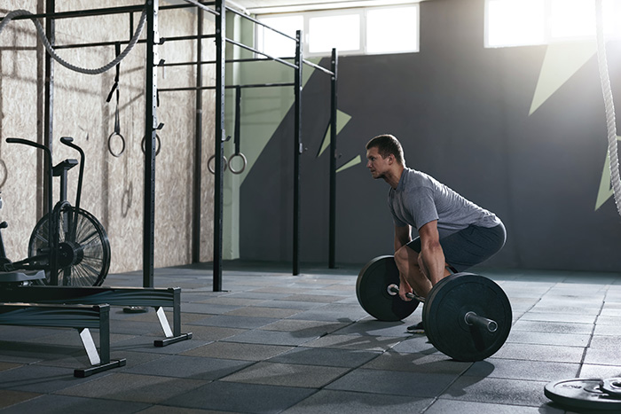 Man gym barbell deadlift strong lean muscular body