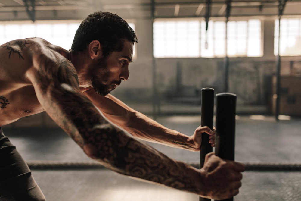 Prowler push HIIT cardio man gym workout strength power muscle calorie burn fat loss